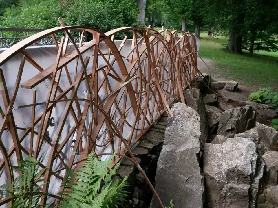 Stahlgeländer der Brücke am Schwanenteich zwischen Felsen und Farnen