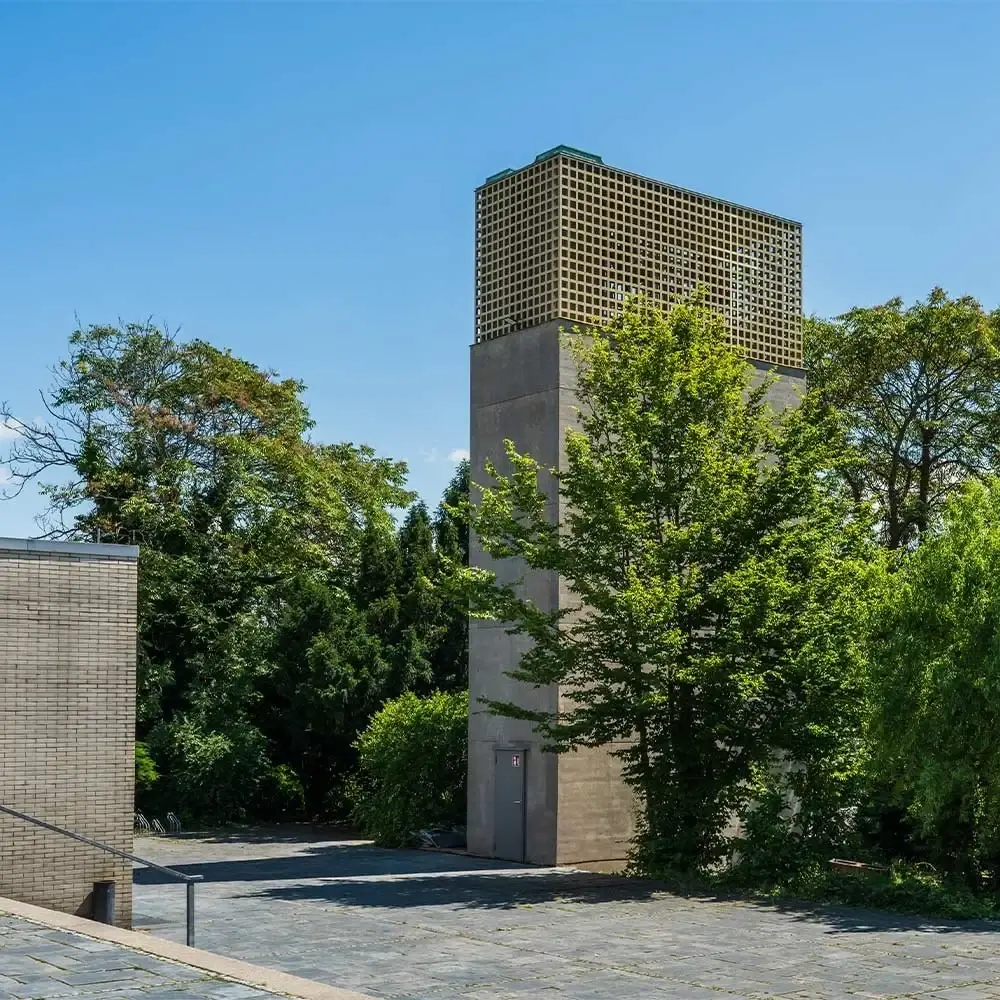 Glockenturm der Auferstehungsgemeinde zwischen Bäumen